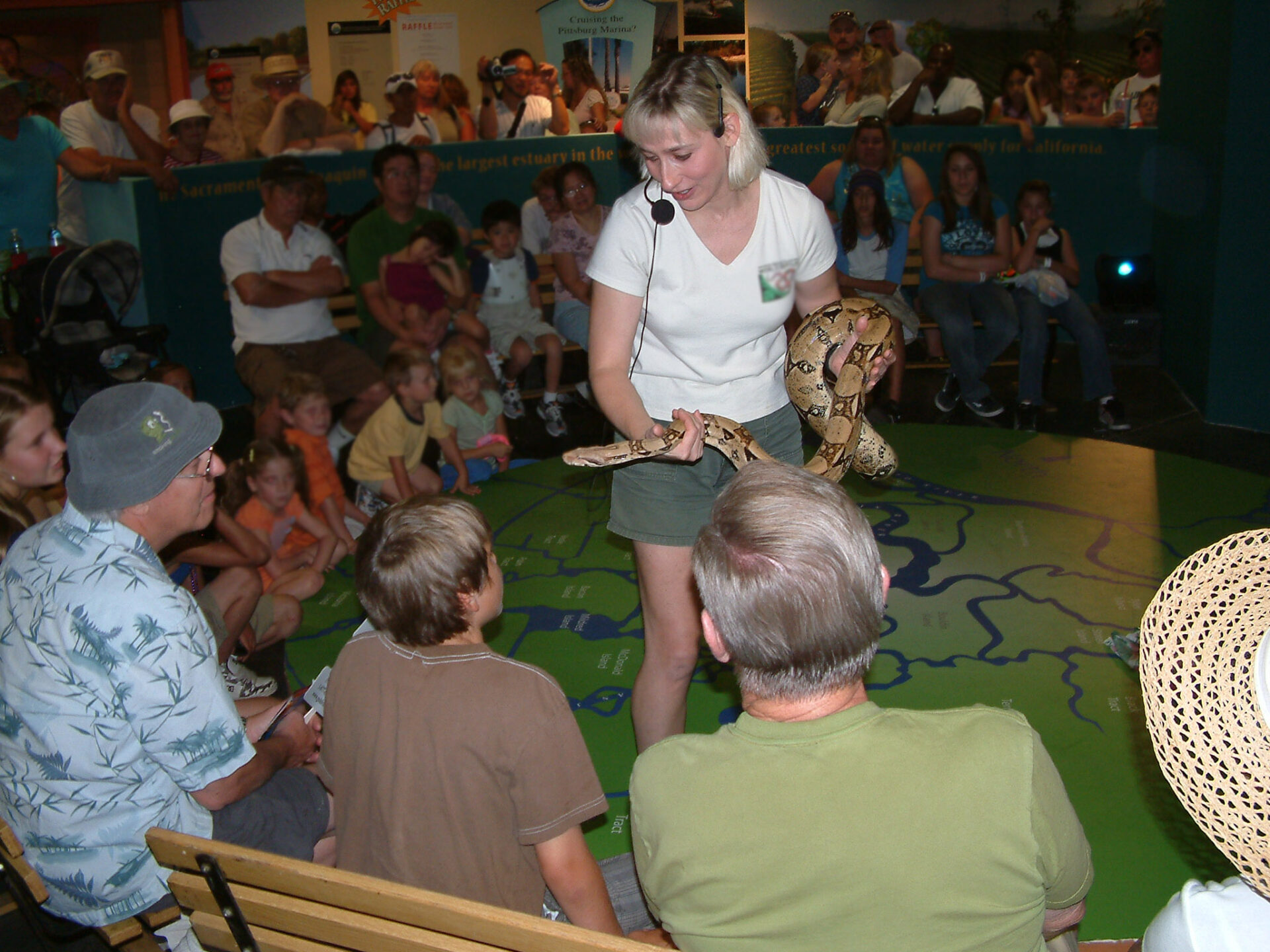 Joy Marzolf from The Joys of Nature educational programs holds a red-tailed boa to a live audience
