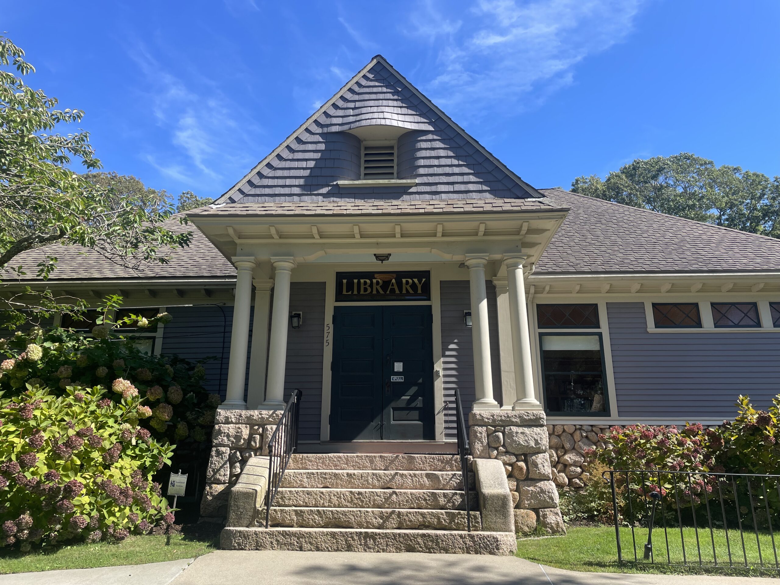 front entrance of West Falmouth Library on a clear sunny day