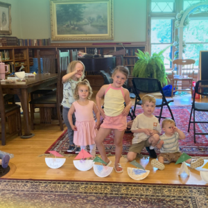 photo of children with paper toy boats