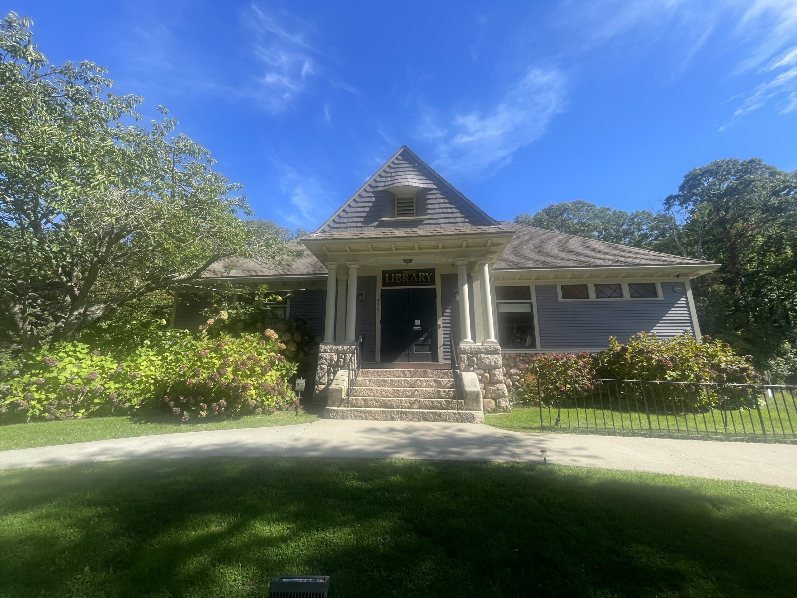 exterior shot of West Falmouth Library under a clear blue sky