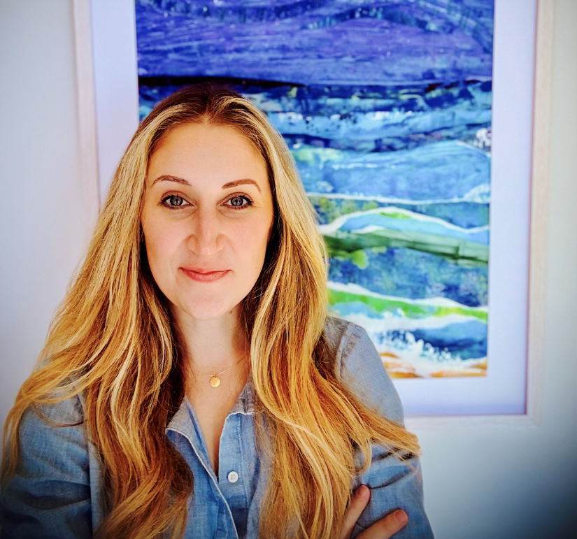 photo of artist Caroline Buccino standing in front of one of her paintings