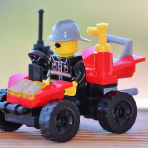 Photo of a Lego Man in a Lego Jeep