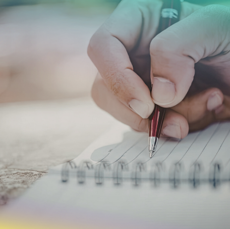 stock photo of pale hand writing in a notebook