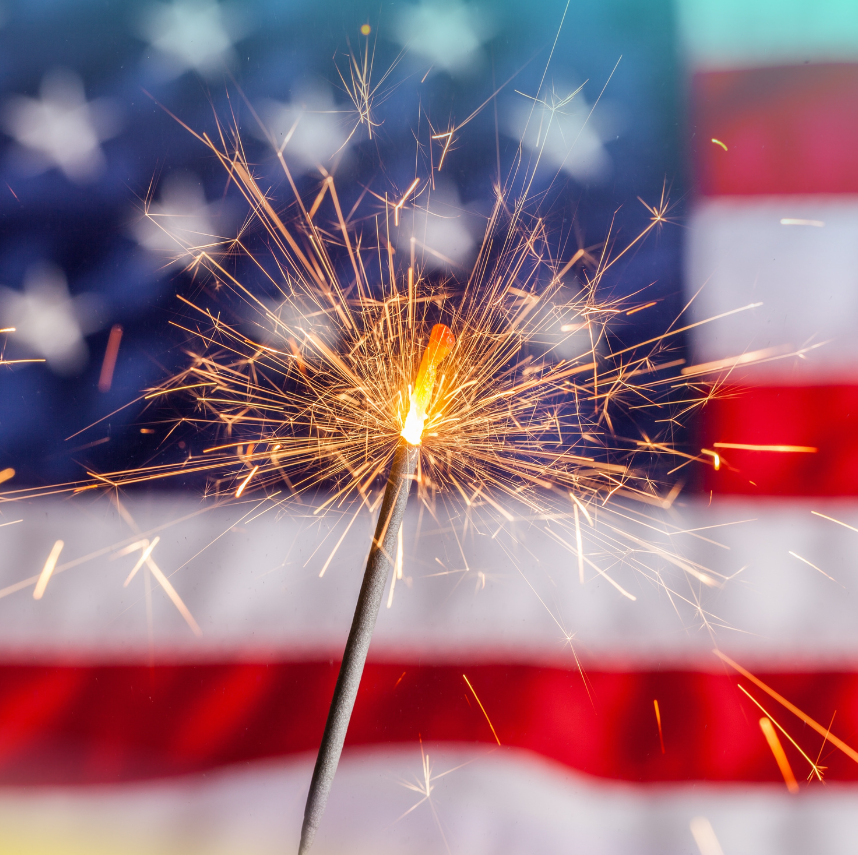 4th of july graphic of a lit sparkler with an American flag in the background