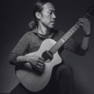 black and white photo of guitarist Hiroya Tsukamoto