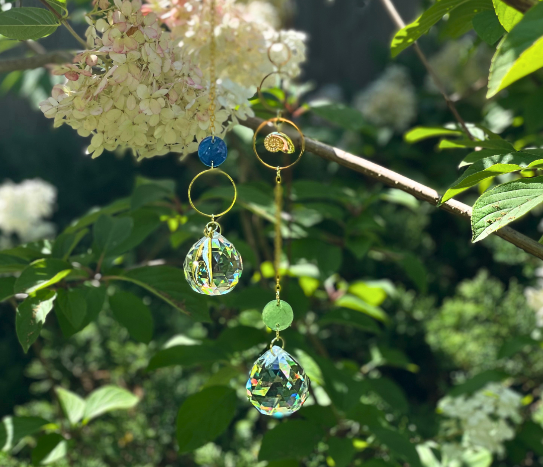 photo of suncatcher prisms hanging in a tree